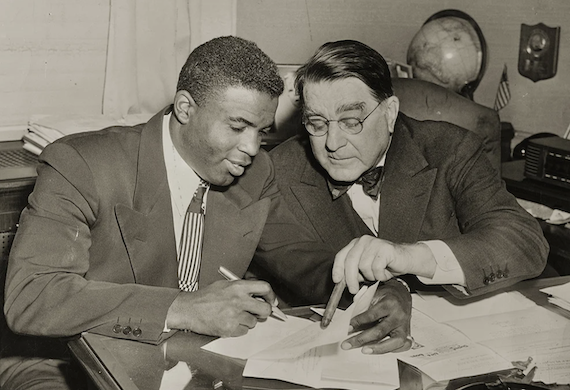 Jackie Robinson signing his first baseball contract in 1948