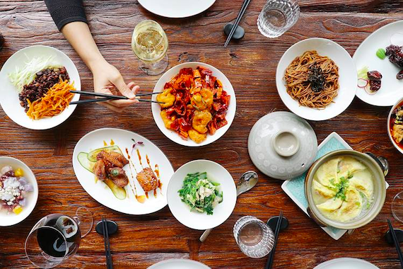 A dinner table featuring a variety of Chinese food dishes